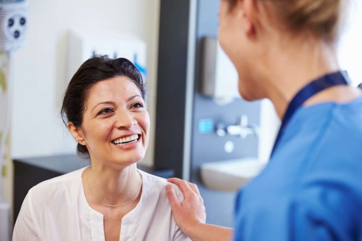 Smiling patient speaking with a dentist during a cosmetic dentistry consultation