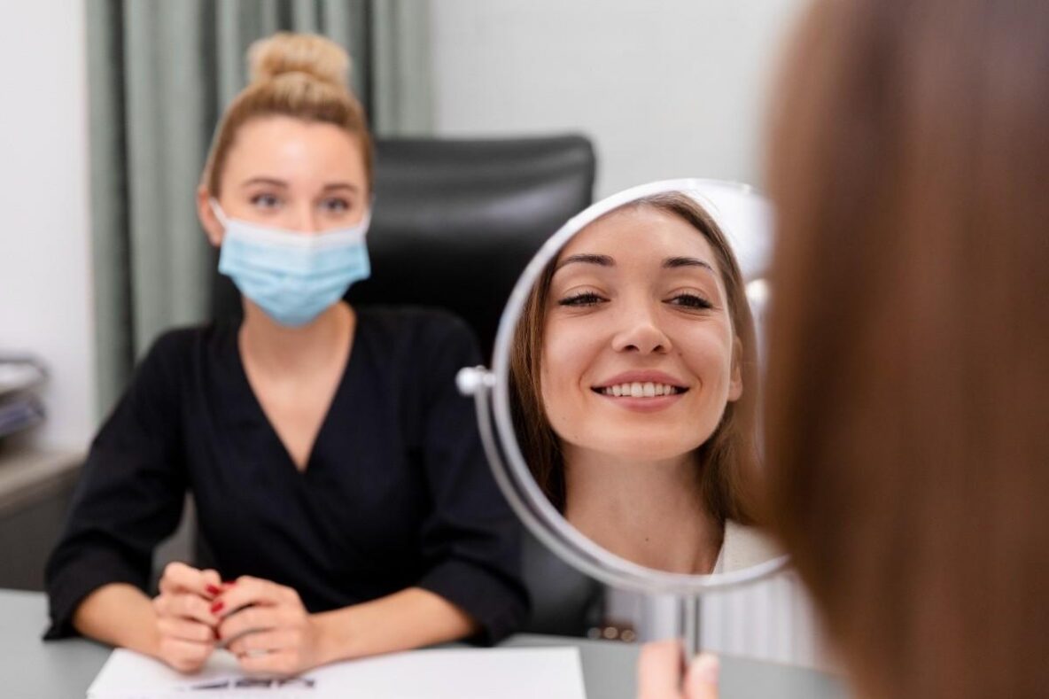 Patient reviewing her smile during a veneers consultation for cosmetic dental improvements